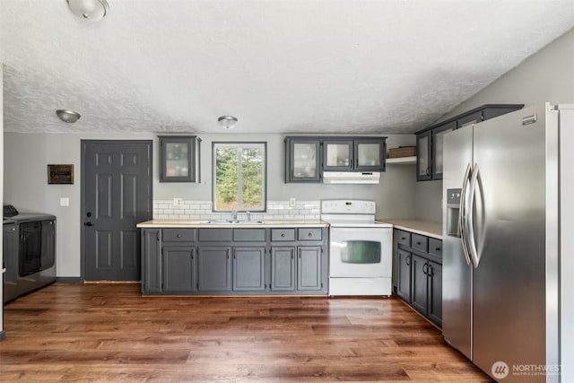 151 Deer Haven Dr, Winlock, WA 98596 - kitchen with washer and clothes dryer, a sink, white electric range, stainless steel refrigerator with ice dispenser, and under cabinet range hood