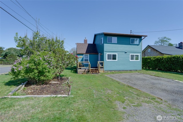 1401 264th Pl, Ocean Park, WA 98640 - back of property featuring a lawn, a chimney, and a deck