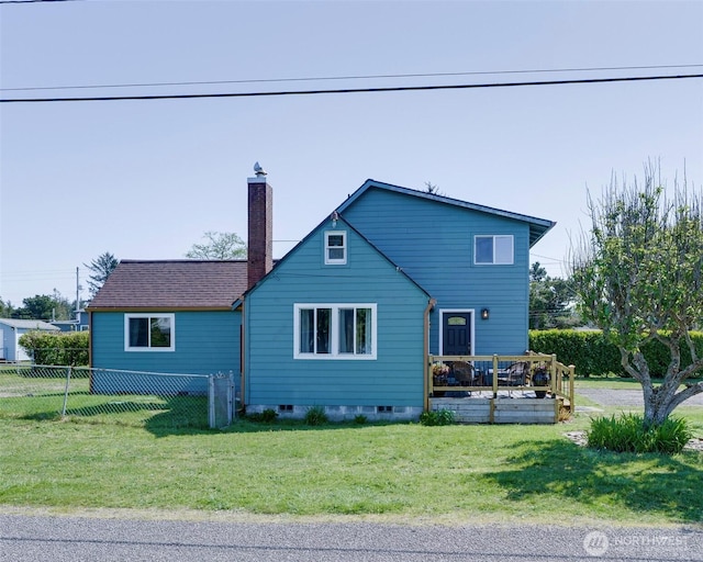 1401 264th Pl, Ocean Park, WA 98640 - view of front of house with a front lawn, fence, a wooden deck, and a chimney