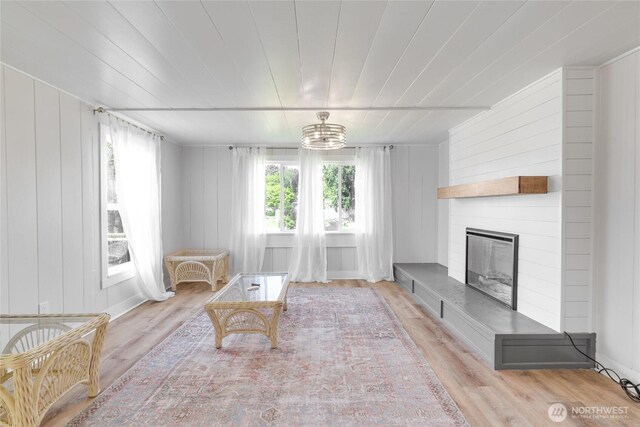 1401 264th Pl, Ocean Park, WA 98640 - living room with wooden walls, a large fireplace, and light wood-style floors