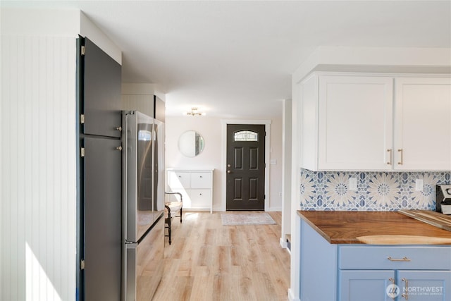 1401 264th Pl, Ocean Park, WA 98640 - kitchen with wooden counters, backsplash, freestanding refrigerator, light wood-style floors, and white cabinetry