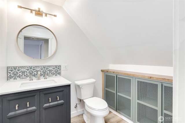 1401 264th Pl, Ocean Park, WA 98640 - bathroom with vanity, backsplash, vaulted ceiling, and toilet