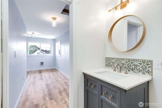 1401 264th Pl, Ocean Park, WA 98640 - bathroom featuring baseboards, tasteful backsplash, wood finished floors, and vanity