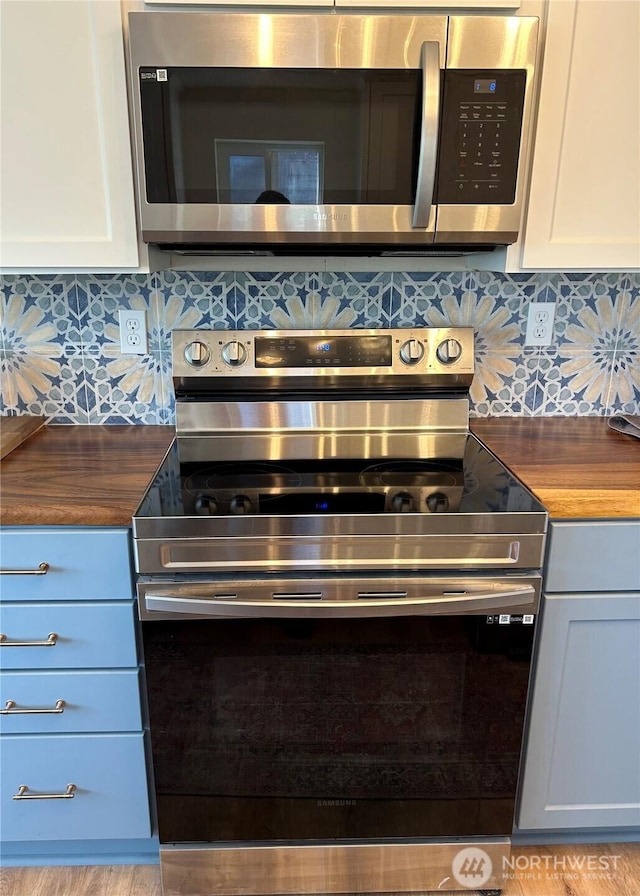 1401 264th Pl, Ocean Park, WA 98640 - details featuring backsplash, wood counters, and appliances with stainless steel finishes