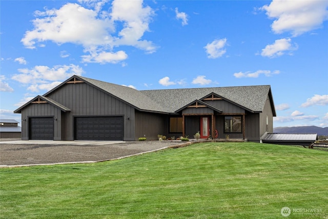 2351 Lower Green Canyon Rd, Ellensburg, WA 98926 - view of front of house with a shingled roof, an attached garage, board and batten siding, a front lawn, and driveway