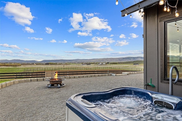 2351 Lower Green Canyon Rd, Ellensburg, WA 98926 - view of patio / terrace featuring a mountain view, fence, a hot tub, and a rural view