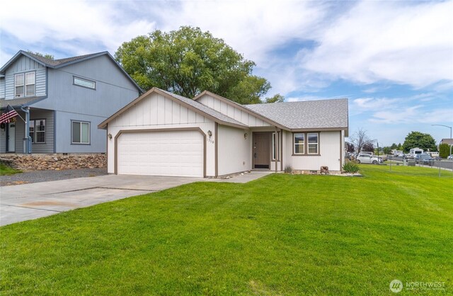 1310 W Virginia St, Moses Lake, WA 98837 - view of front of house featuring a garage, concrete driveway, and a shingled roof