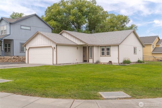 1310 W Virginia St, Moses Lake, WA 98837 - view of front of house with an attached garage, roof with shingles, and a front lawn