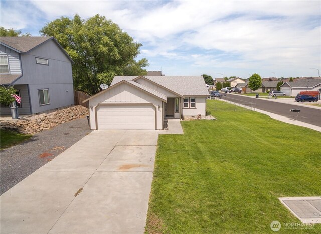 1310 W Virginia St, Moses Lake, WA 98837 - view of front of property featuring a shingled roof, driveway, a front yard, a garage, and a residential view