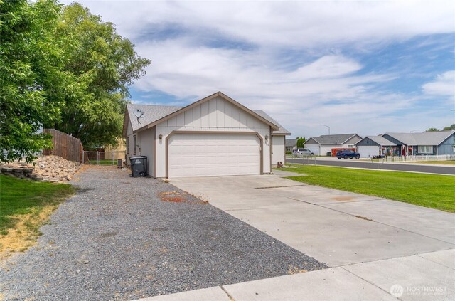 1310 W Virginia St, Moses Lake, WA 98837 - view of front of house with driveway, an attached garage, and a residential view