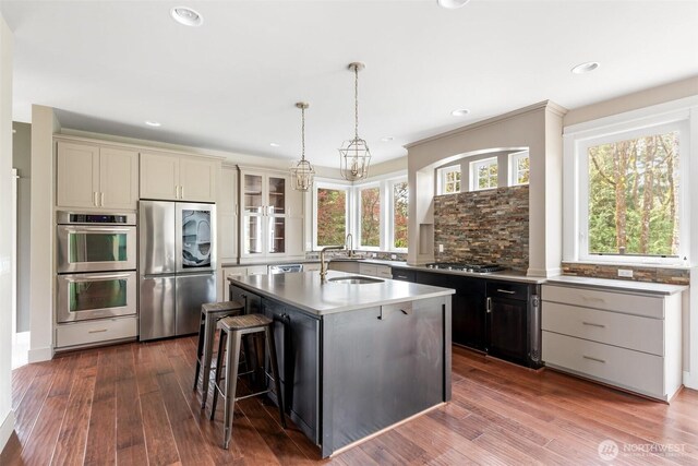 107 Nicola Ct, Chehalis, WA 98532 - kitchen with appliances with stainless steel finishes, a kitchen breakfast bar, recessed lighting, dark wood finished floors, and a sink