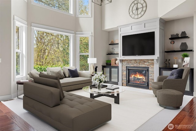 107 Nicola Ct, Chehalis, WA 98532 - living area featuring a towering ceiling, a stone fireplace, built in features, and wood finished floors