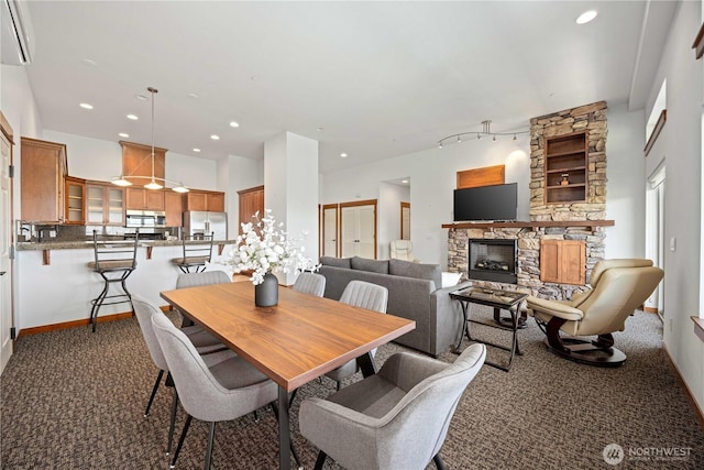 dining space with carpet floors, a fireplace, and recessed lighting