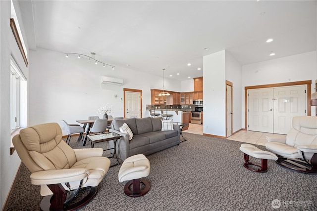 living room with recessed lighting, a wall mounted air conditioner, light colored carpet, and light tile patterned flooring