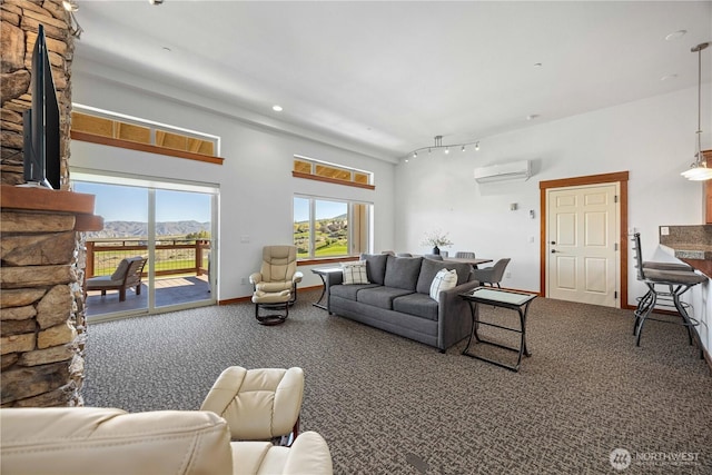 carpeted living area with a fireplace, recessed lighting, and a wall unit AC