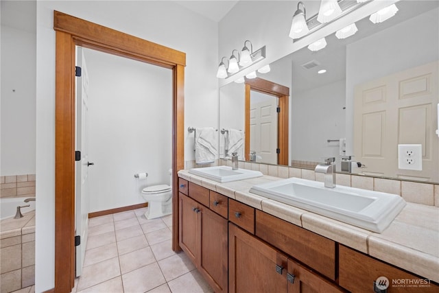 bathroom featuring tile patterned flooring, visible vents, toilet, and a sink