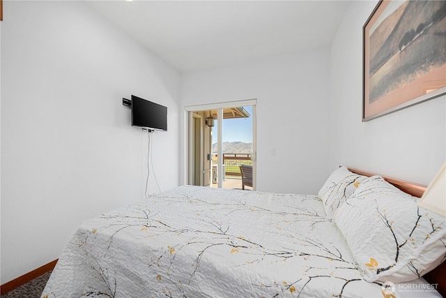 carpeted bedroom featuring baseboards and access to exterior