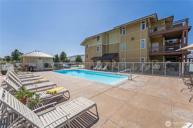 pool featuring fence and a patio