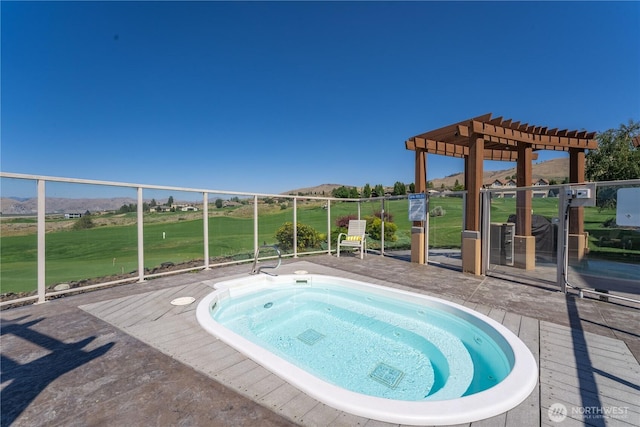 view of swimming pool featuring a pergola, view of golf course, an in ground hot tub, and a mountain view