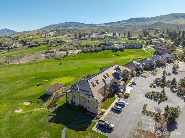 birds eye view of property featuring view of golf course, a residential view, and a mountain view