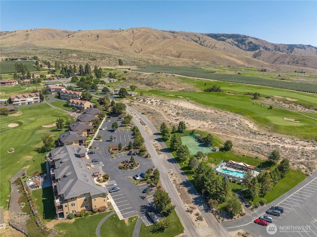 birds eye view of property with golf course view and a mountain view