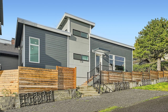 modern home featuring fence