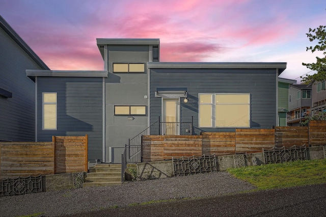 contemporary house with fence