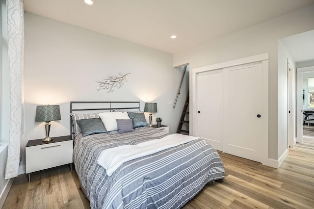 bedroom with recessed lighting, a closet, baseboards, and wood finished floors