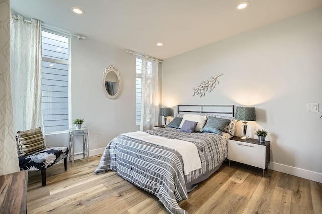 bedroom with baseboards, recessed lighting, and wood finished floors