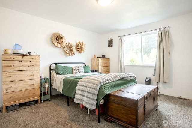 carpeted bedroom featuring visible vents