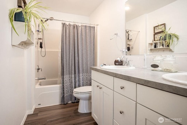 full bathroom with a sink, shower / tub combo with curtain, double vanity, toilet, and wood finished floors