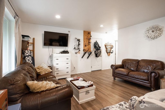 living area with baseboards, recessed lighting, and wood finished floors