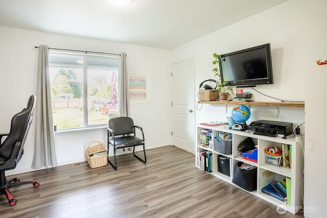 interior space with baseboards and wood finished floors