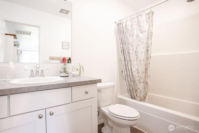 bathroom with visible vents, shower / bath combo with shower curtain, toilet, and vanity