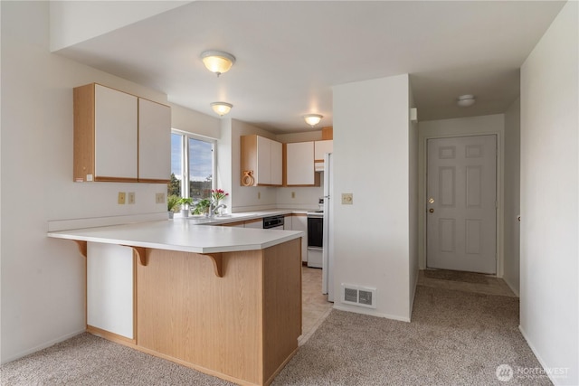 730 SE 8th Ave Unit G202, Oak Harbor, WA 98277 - kitchen featuring visible vents, white range with electric cooktop, light colored carpet, and a peninsula
