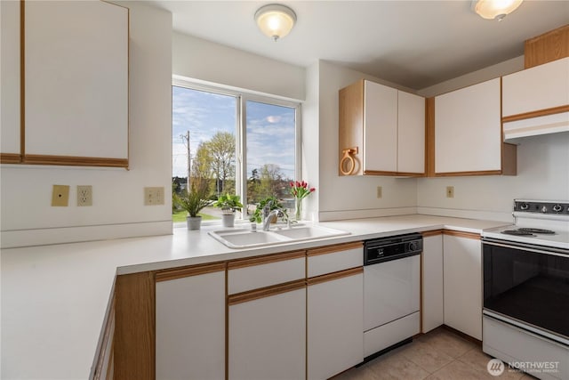 730 SE 8th Ave Unit G202, Oak Harbor, WA 98277 - kitchen with white appliances, white cabinetry, light tile patterned flooring, light countertops, and a sink