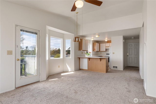 730 SE 8th Ave Unit G202, Oak Harbor, WA 98277 - unfurnished living room featuring visible vents, light colored carpet, a ceiling fan, and lofted ceiling