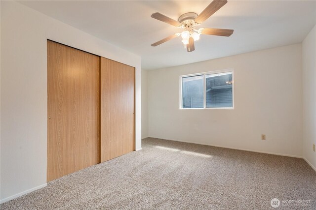 730 SE 8th Ave Unit G202, Oak Harbor, WA 98277 - unfurnished bedroom featuring a closet, baseboards, a ceiling fan, and carpet