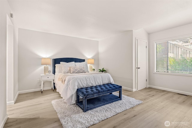 13730 15th Ave NE Unit F-103, Seattle, WA 98125 - bedroom featuring baseboards and light wood-style floors