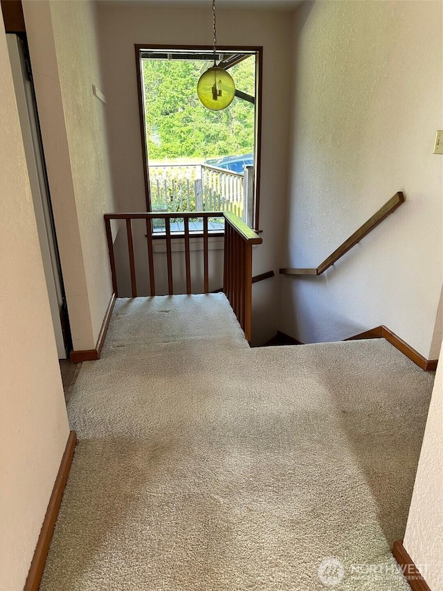6255 Turkey Hill Rd, Clinton, WA 98236 - staircase featuring carpet, a textured wall, and baseboards