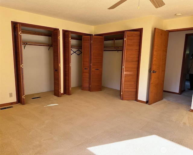6255 Turkey Hill Rd, Clinton, WA 98236 - unfurnished bedroom with carpet flooring, two closets, and ceiling fan