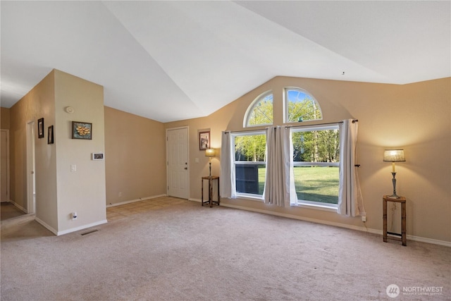 unfurnished living room with carpet flooring, visible vents, baseboards, and vaulted ceiling