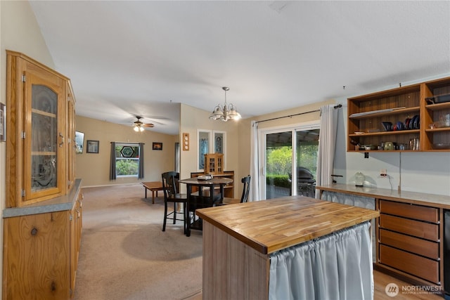 kitchen featuring butcher block counters, light colored carpet, open shelves, and plenty of natural light