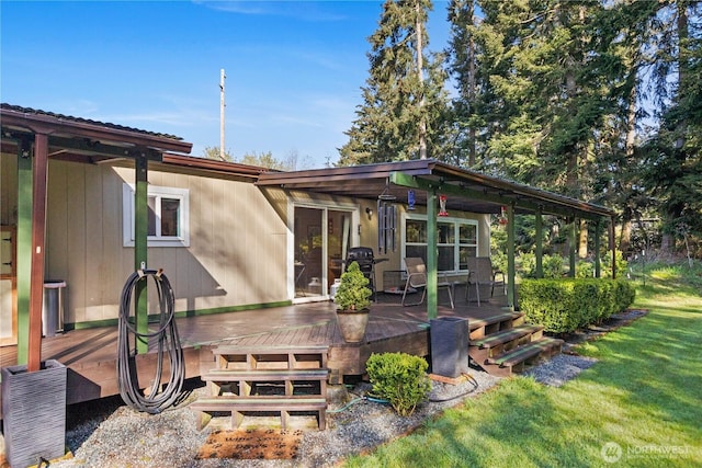 rear view of property with a deck and a lawn