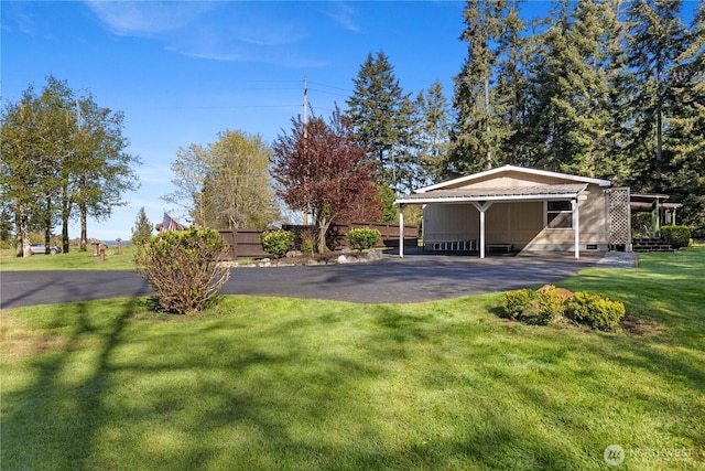 view of yard with a carport and fence