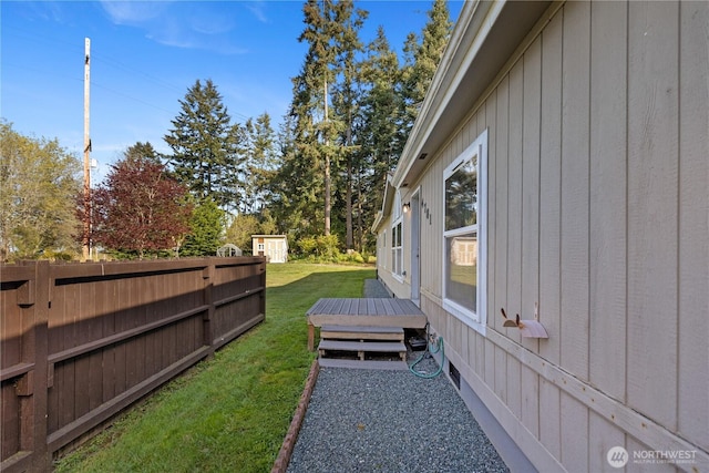 view of yard with fence and a deck