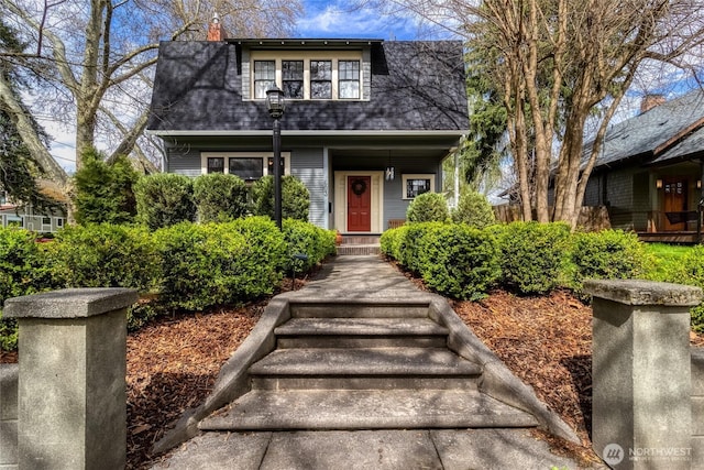 view of front of home with a shingled roof