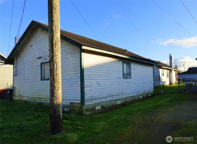 view of home's exterior with crawl space and a yard