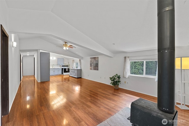 5675 Winona Ln, Langley, WA 98260 - unfurnished living room featuring light wood finished floors, vaulted ceiling, and a ceiling fan