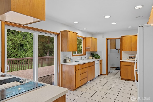 5675 Winona Ln, Langley, WA 98260 - kitchen with white appliances, light countertops, decorative backsplash, and a healthy amount of sunlight